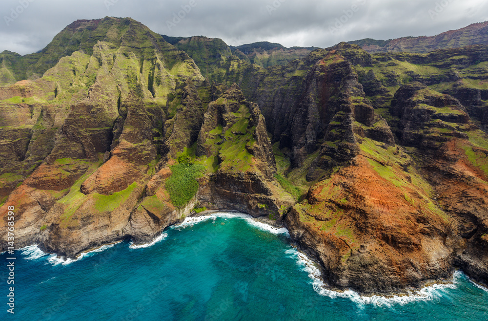 View of the monumental Na Pali Coast at Puanaiea Point, aerial shot from a helicopter, Kauai, Hawaii.