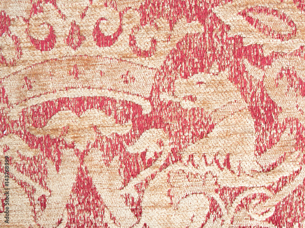 Texture of old textile vintage background with a pattern of red color closeup