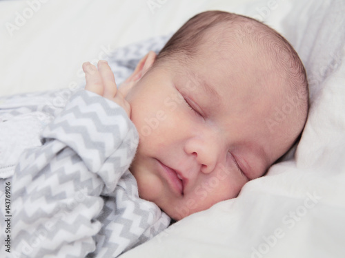 Cute newborn baby sleeping, face closeup