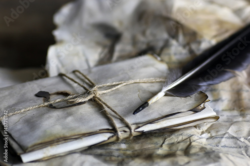 old paper letter feather