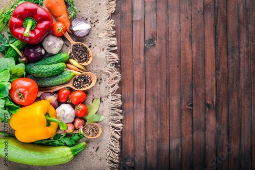 Frame of organic food. Fresh raw vegetables and spices. On a wooden chalkboard.