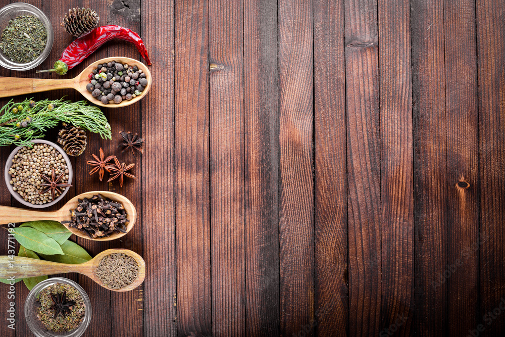 A mixture of spices. Wooden spoon. On Wooden background. Top view. A mixture of spices. Wooden spoon. On Wooden background. Top view.