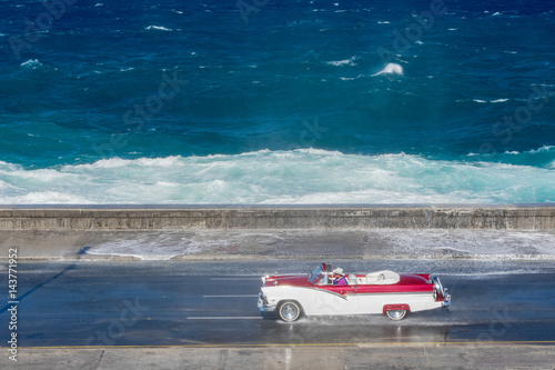 old american car riding at Malecon, Havana