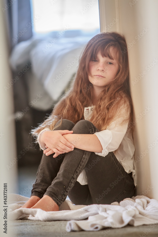 young preteen  Foto Stock indoor portrait of young preteen girl at home | Adobe Stock