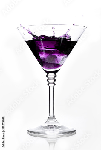Purple cocktail glass with a white background.