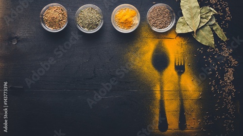 Fototapeta Naklejka Na Ścianę i Meble -  Ground colorful Indian spices and herbs. On the black chalkboard.