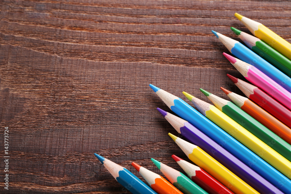 Drawing colourful pencils on brown wooden table Drawing colourful pencils on brown wooden table