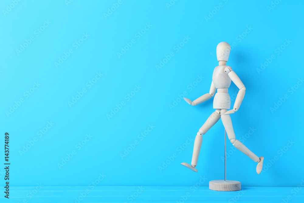 Wooden figure on the blue background Wooden figure on the blue background