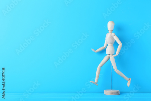 Wooden figure on the blue background