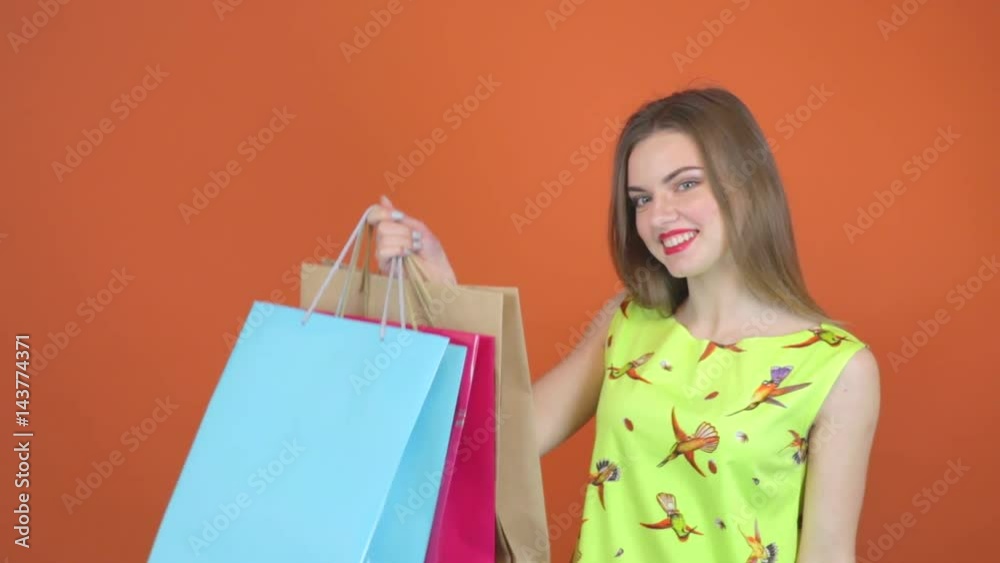 Beautiful young woman in green dress with shopping bags Beautiful young woman in green dress with shopping bags
