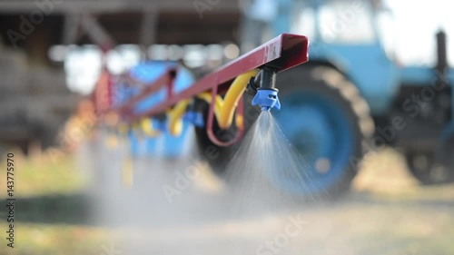 The tractor sprinkles the pesticides
