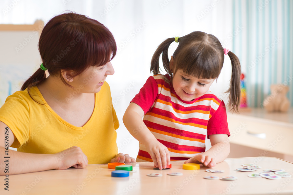 Young woman plays with kid educational game Young woman plays with kid educational game