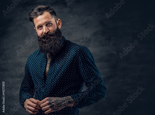 Stampa su tela Bearded tattooed male dressed in dark blue jacket.