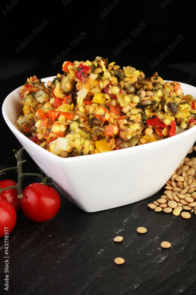 Lentil with carrot and pumpkin ragout in a wooden bowl on a wood Lentil with carrot and pumpkin ragout in a wooden bowl on a wood