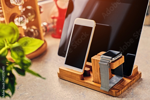 Bamboo wooden stand with smart watch, tablet PC and smart phone.