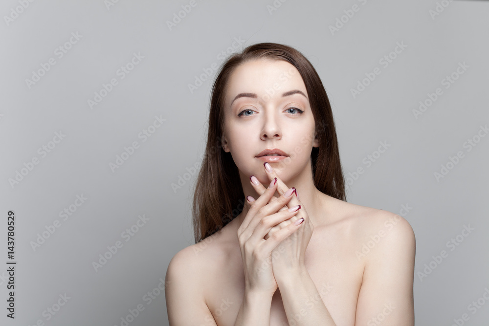 Isolated on gray background studio portrait of young brunette with manicure on nails Isolated on gray background studio portrait of young brunette with manicure on nails