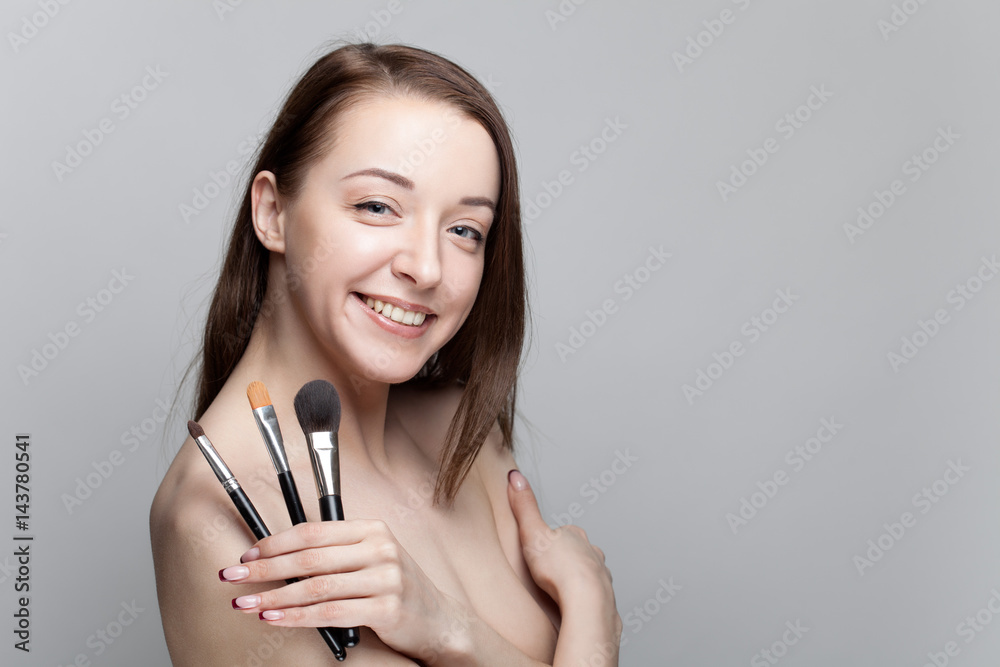 Isolated studio portrait of a young girl on a gray background Isolated studio portrait of a young girl on a gray background