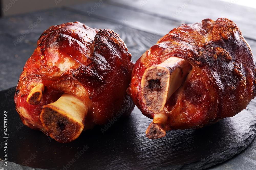 Ταπετσαρία Smoked ham hock with herbs and spices on wooden plate.