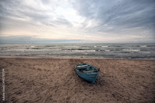 Beautiful landscape of Boat on the beach in cloudy weather. Vintage Boat in the seashore. Azerbaijan Caspian Sea Novkhani