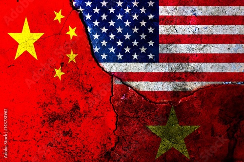 Cracks in the wall. Flags: USA, China, Vietnam photo