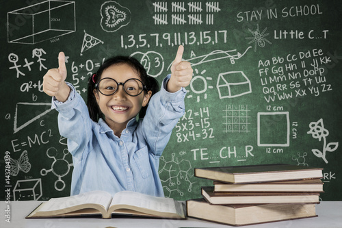 Little student showing ok sign with scribble