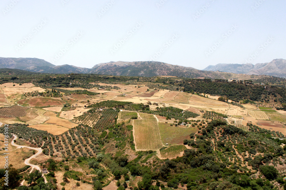 Spain. Andalucia. Ronda. Mountains and field on blue sky background, horizontal view.