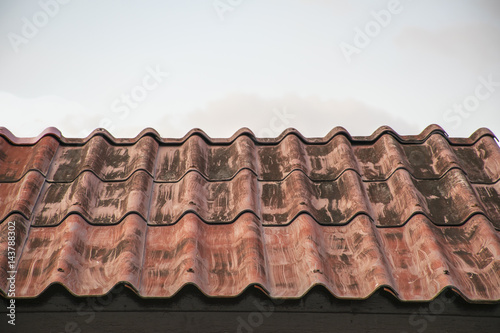 red roof tiles texture with blue sky background.