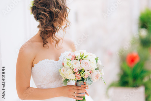 Wedding bridal bouquet of Lisianthus and Cineraria silver in the hands of the bride. Wedding in Montenegro.