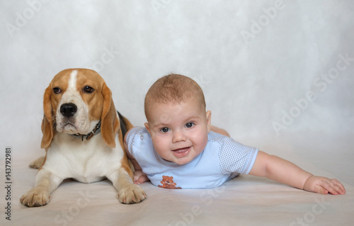 Portrait of a baby with a Beagle on a white background
