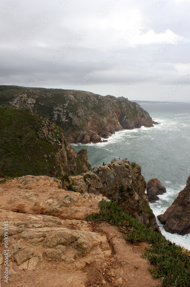 Portugal. Cabo da roca. Rock and atlantic ocean on sky with clouds background, vertical view.