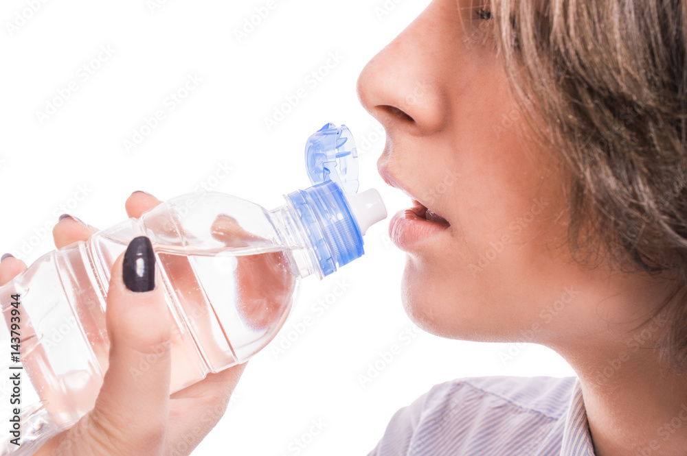 Woman is drinking water on a white background Woman is drinking water on a white background