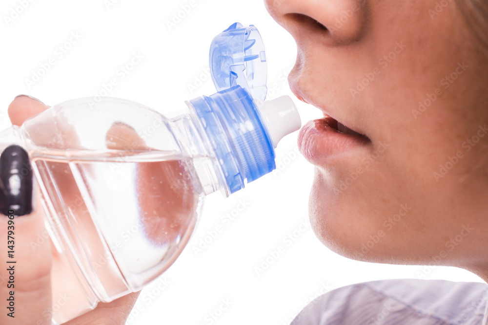 Woman is drinking water on a white background Woman is drinking water on a white background