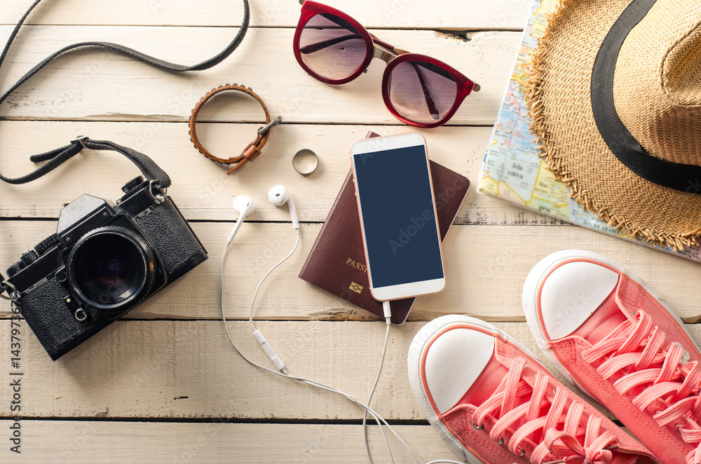 Tourism planning and equipment needed for the trip on wooden floor Tourism planning and equipment needed for the trip on wooden floor