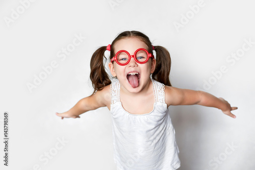 smiling little girl in red toy glasses