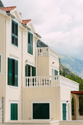 Green window shutters. The facade of houses in Montenegro.