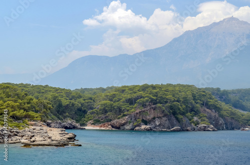 Resort Turkish. Blue water of the Mediterranean Sea. Beautiful amazing nature background. Huge rocks. Fresh freedom of the sea. Adventure day. A splendid paradise. The inspirational desert of water.
