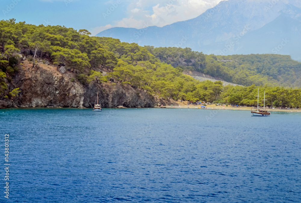 Resort Turkish. Blue water of the Mediterranean Sea. Beautiful amazing nature background. Huge rocks. Fresh freedom of the sea. Adventure day. A splendid paradise. The inspirational desert of water.