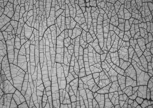Black and white texture of a wall with cracked paint