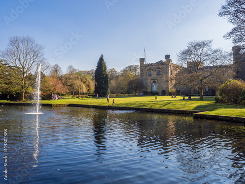 Beautiful summer like weather over lovely pond and fountain at Townley Park, Burnley, Lanvashire, UK