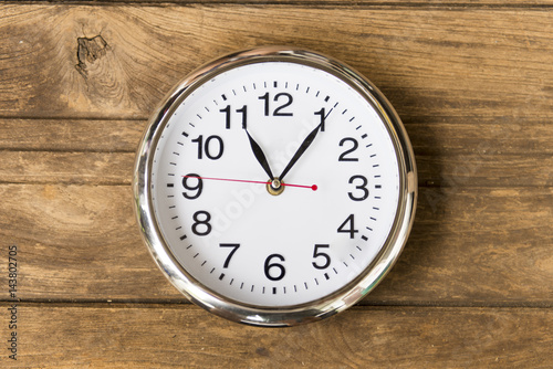 Vintage alarm clock on weathered wood background
