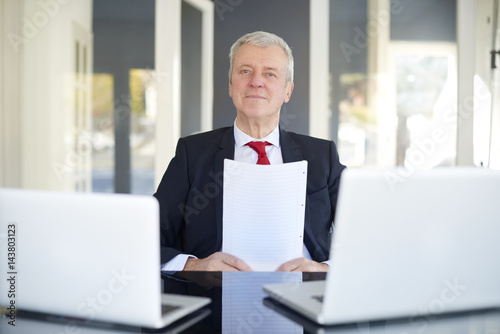 Senior manager portrait. Shot of an old overwhelmed business man working on laptop in the office.