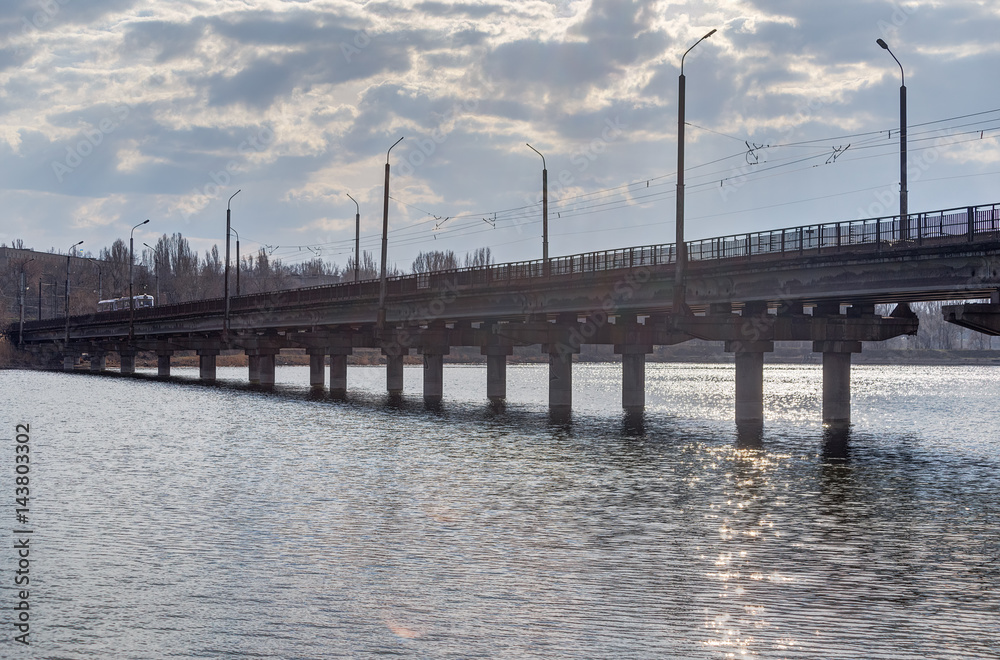 Photo of an industrial bridge through an artificial reservoir in the city.