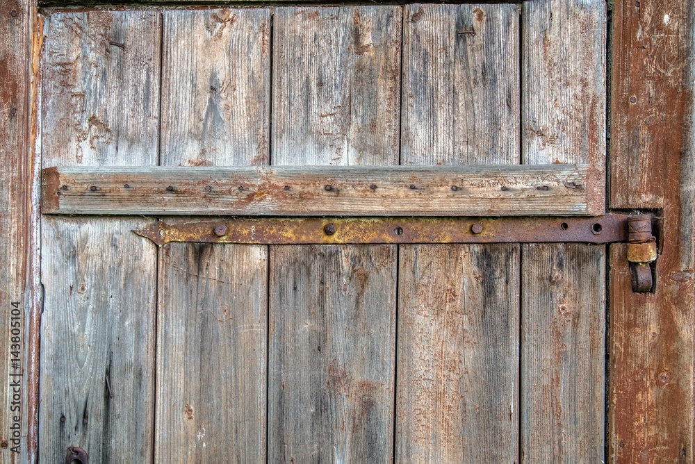 metal part on an old wooden door metal part on an old wooden door