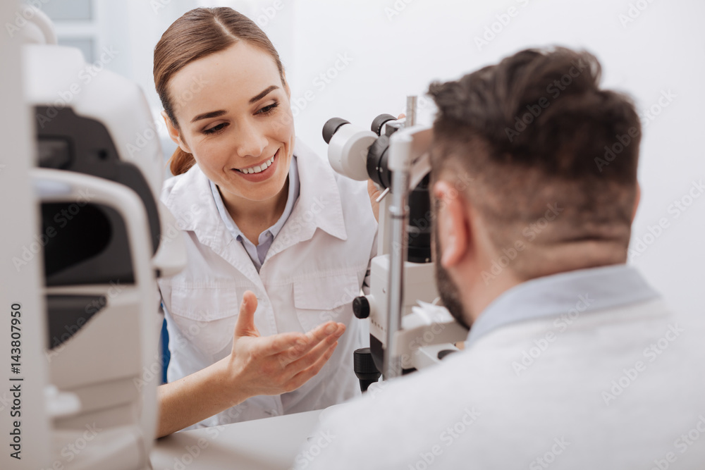 Delighted friendly optometrist interacting with her patient Delighted friendly optometrist interacting with her patient