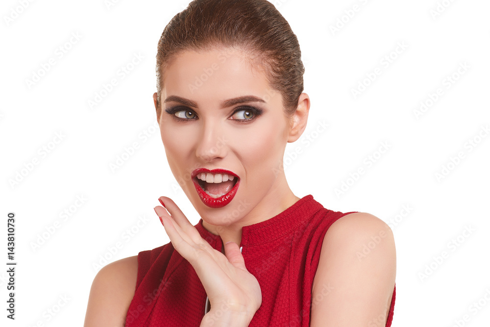 Portrait of a cheerful young brunette woman in red dress posing and looking away over white background Portrait of a cheerful young brunette woman in red dress posing and looking away over white background
