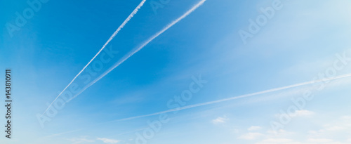 Blue sky with contrails photo
