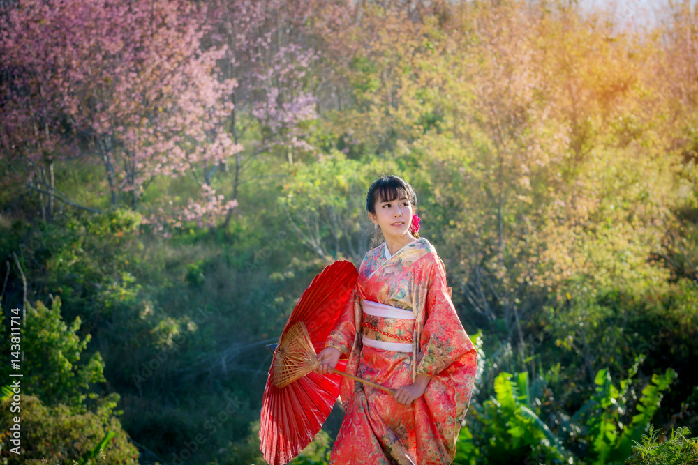 Asian Women in kimono traditional dress holding red umbrella of a Japanese is a very beautiful