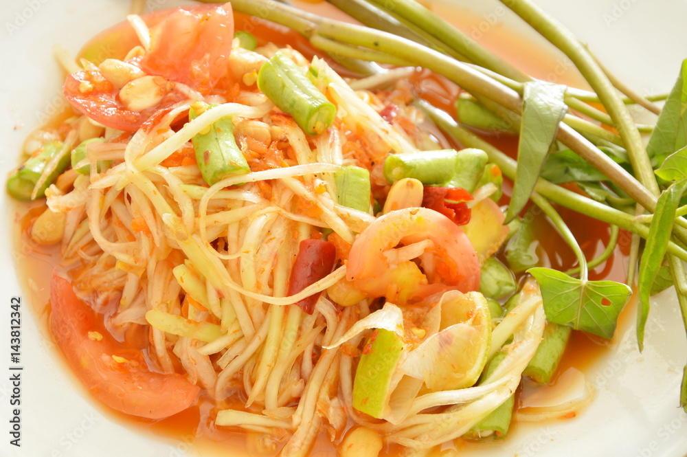 Somtum Thai green papaya salad tasted spicy sour and sweet on dish Somtum Thai green papaya salad tasted spicy sour and sweet on dish