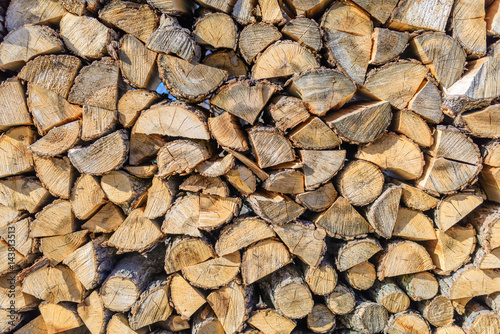 Obraz na płótnie Chopped brown firewood, stacked and ready for winter. Stack of wood detailed background photo texture. w salonie