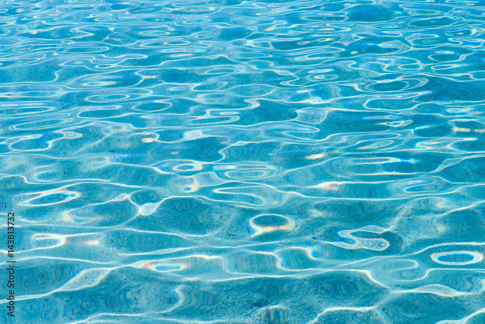 Shining blue water ripple background. Clear sea water background. Photo from Kalamitsi, Sitonia, Halkidiki, Macedonia, Northern Greece.